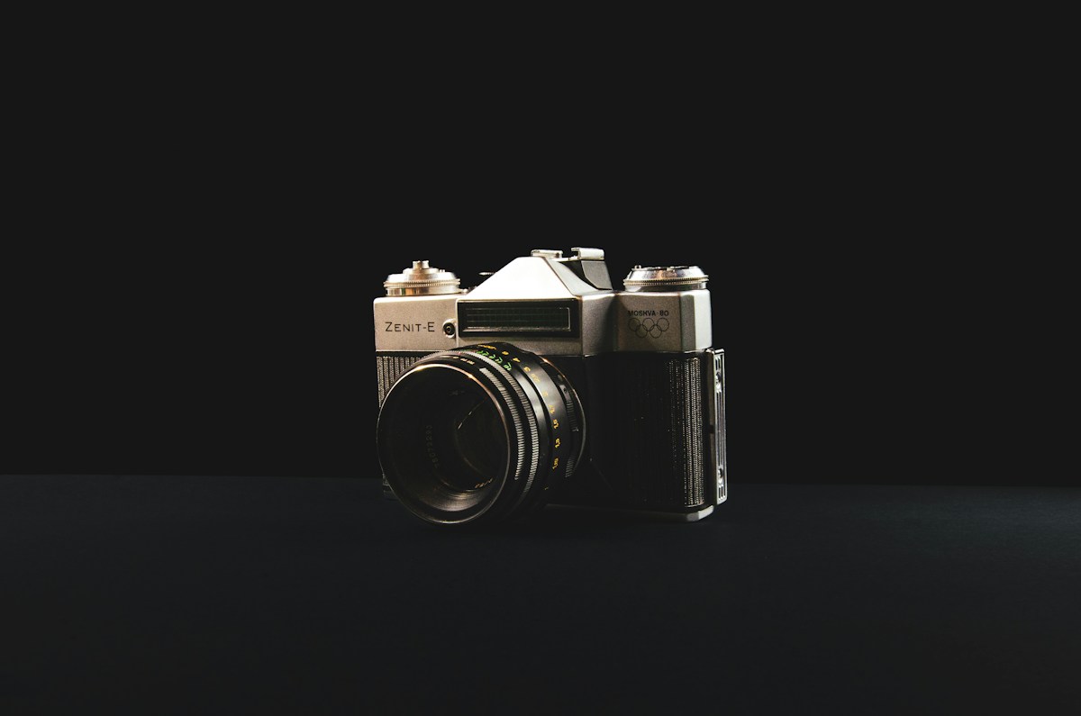 Vintage film camera photographed against a black background